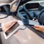 girl driver makes NFC payment with her mobile phone, contactless payment method for services