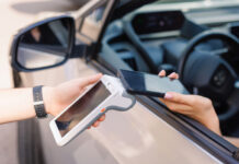 girl driver makes NFC payment with her mobile phone, contactless payment method for services