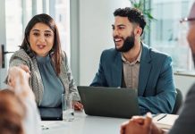 Business people and laptop with handshake in meeting