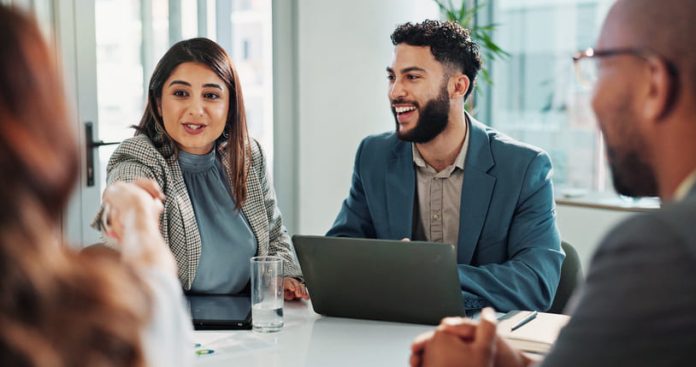 Business people and laptop with handshake in meeting