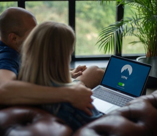 Couple using laptop with VPN on screen