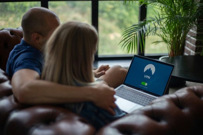 Couple using laptop with VPN on screen