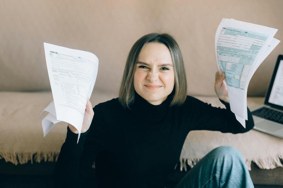 Woman in black long sleeve holding papers