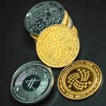 IOTA coin together on a black surface