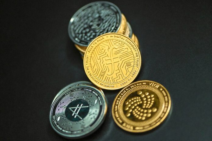 IOTA coin together on a black surface