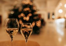 two glass of wine on a table in front of a Christmas tree