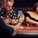 group of people playing igaming in casino together.