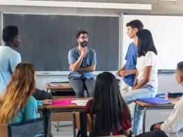 Students having conversation with their professor