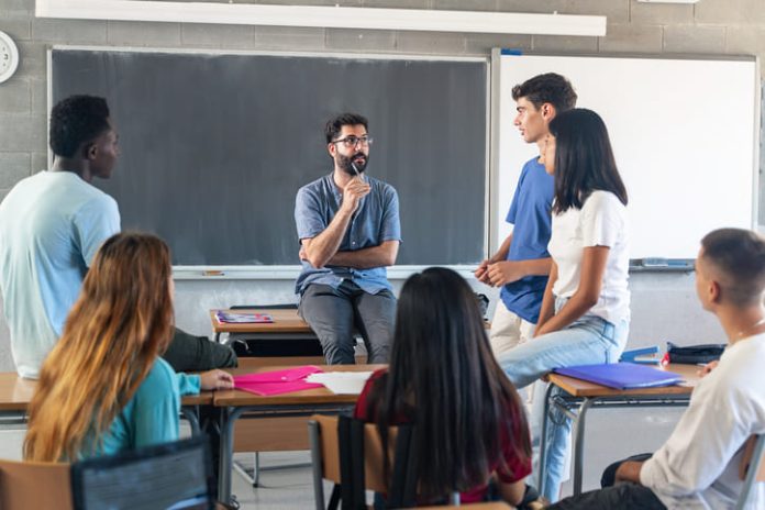 Students having conversation with their professor