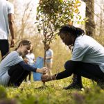 Two diverse activists working together to plant more trees and greenery in relation to social science and sociology