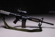 Army assault rifle with optical sight and tactical belt