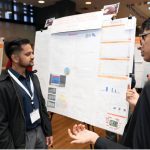 Two indians discussing a presentation related to AI healthcare