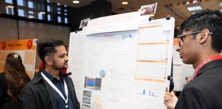 Two indians discussing a presentation related to AI healthcare