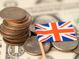 Loan providers in UK. United Kingdom Flag on coins background