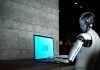 AI robot working on computer. Agentic AI concept