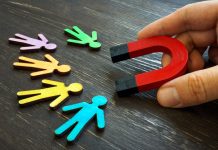 The manager holds a magnet for customers