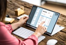 Woman working on computer with invoice software