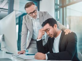 Business leader comforting employee with climate anxiety