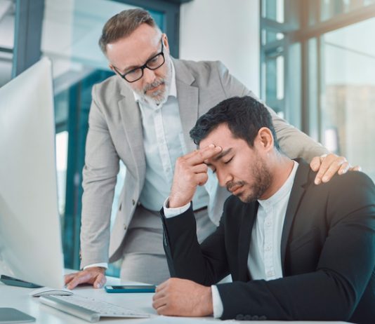 Business leader comforting employee with climate anxiety
