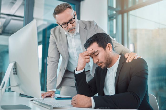Business leader comforting employee with climate anxiety