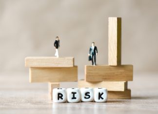 Risk business and SME concept, business man stands on wooden blocks. risk control and managment idea