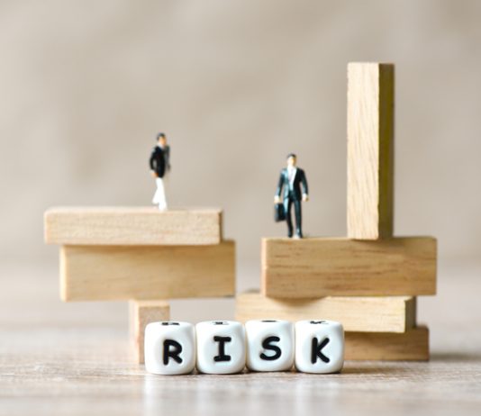 Risk business and SME concept, business man stands on wooden blocks. risk control and managment idea