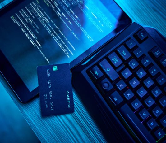 Information technology, hacking and credit card for cyber security crime in bank, phishing and software on digital tablet. Html script, screen and fintech of data fraud, password and coding on dark neon desk