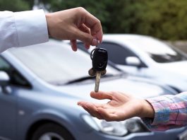 The car salesman and the key to the new owner.