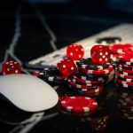 Poker chips lie on the keyboard. Online casino and gamification concept