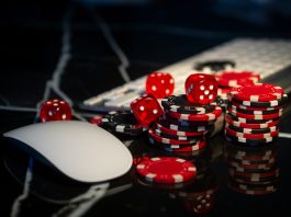 Poker chips lie on the keyboard. Online casino and gamification concept