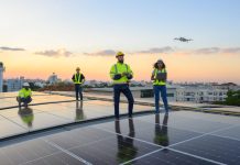A team of engineers flies a drone to plan the installation of an outdoor solar panel system. Installing solar cells on the roof Solar panels on the roof Workers install eco-technology solar power plan.