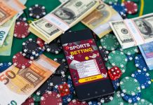 Gold inscription Sports Betting on a smartphone on the background of the stadium.