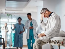 Doctor in the healthcare industry feeling tired from and emotional labor