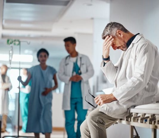 Doctor in the healthcare industry feeling tired from and emotional labor