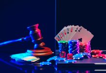 A gavel, handcuffs, playing cards, and player gambling chips are arranged against a dark blue background with neon lights.