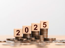 2025 new year goal plan action with 2025 in wooden cube with pile of growing coins