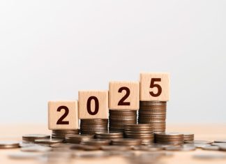 2025 new year goal plan action with 2025 in wooden cube with pile of growing coins