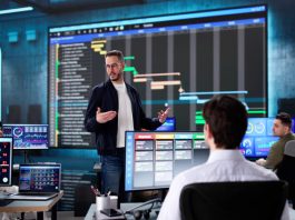 Multiracial executive training room presenting data