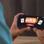 Man winning jackpot on online casino app on a smartphone. Online casino gambling development concept.
