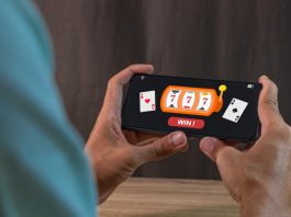 Man winning jackpot on online casino app on a smartphone. Online casino gambling development concept.