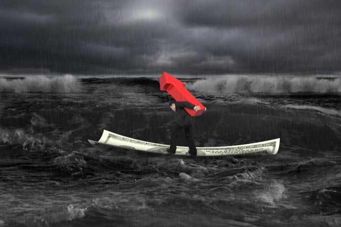 Businessman carrying red arrow up sign on money boat in dark stormy sea with waves coming. Growing business concept